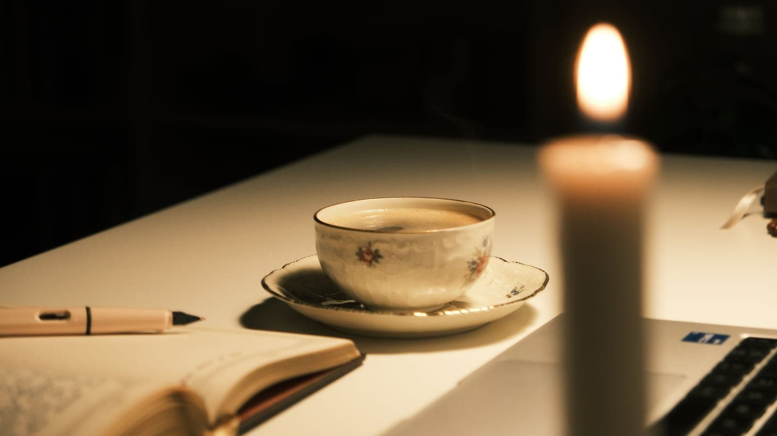 A quiet writing desk with a notebook in warm interior light