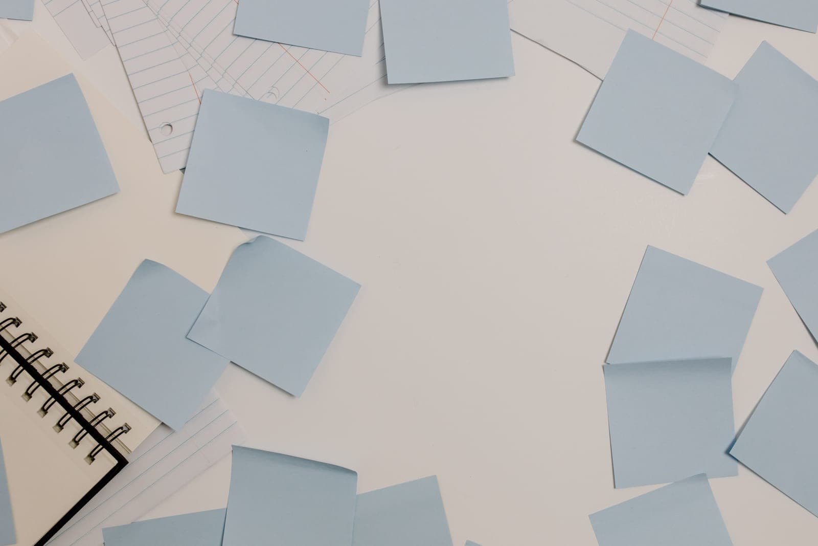 Sticky notes and a pen on a desk surface