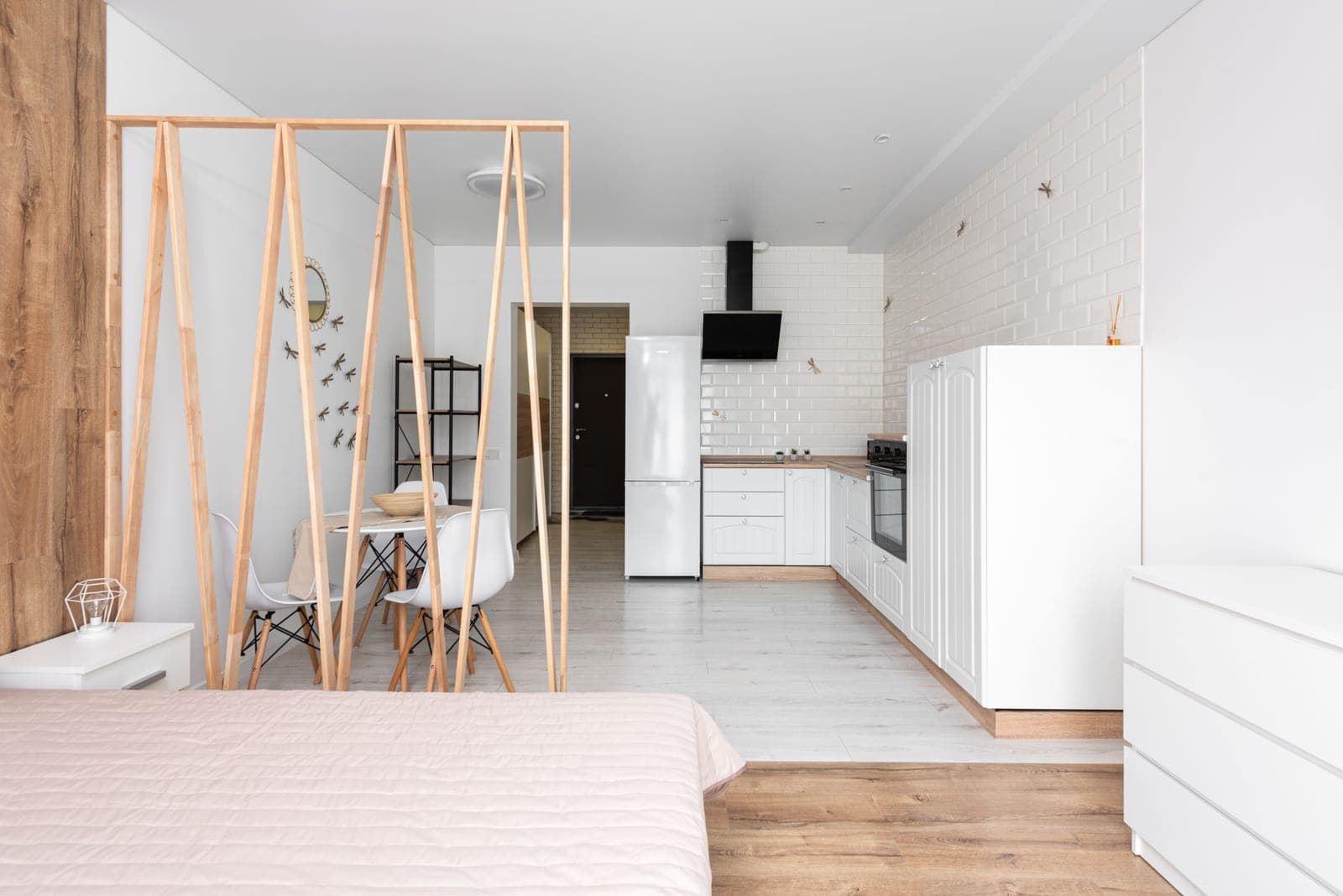 A studio apartment with a desk zoned off from the living space