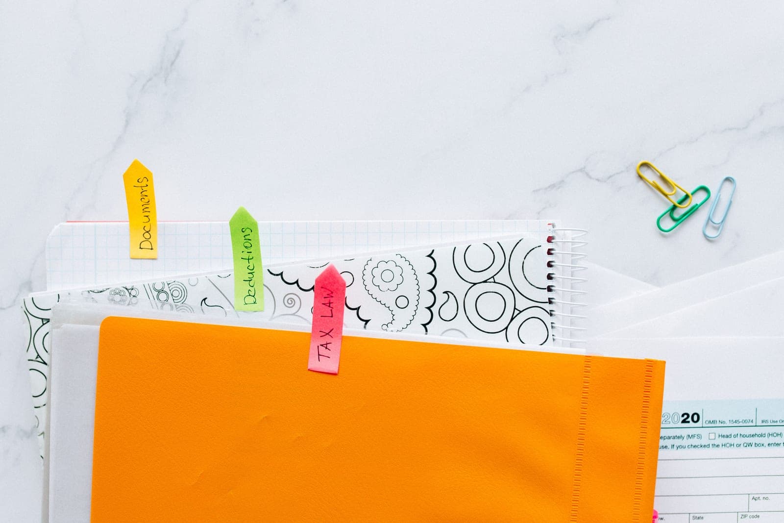 Sorted piles of paper documents with labels on a table