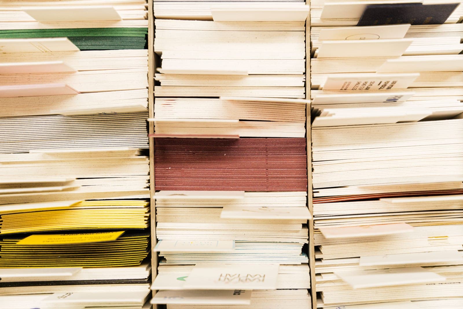 Manila folders with tabs sorted in an archive drawer